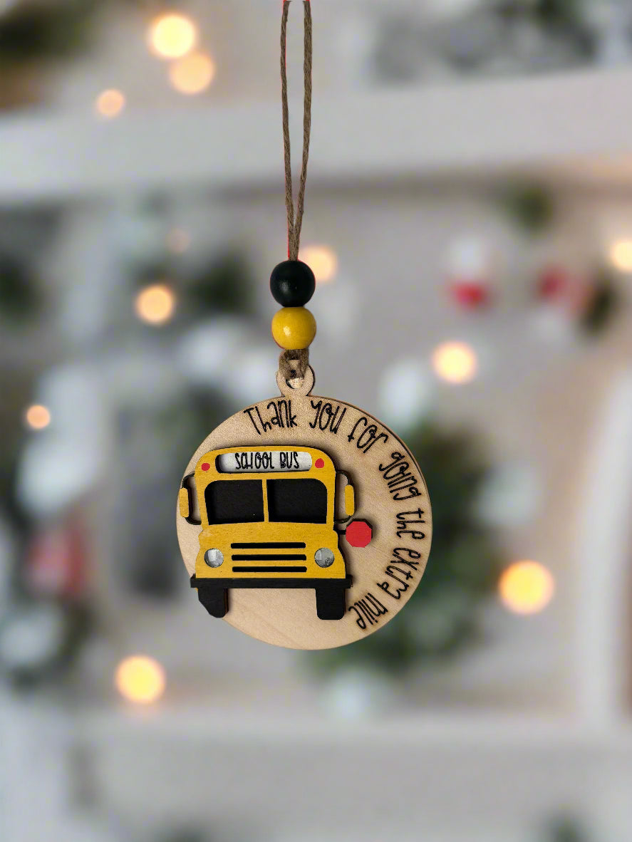 Wooden Christmas Ornament with a school bus design and saying "Thank you for going the extra mile"